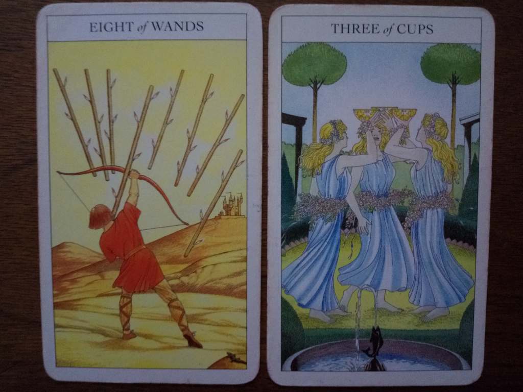 Two tarot cards, the Eight of Wands and Three of Cups.
