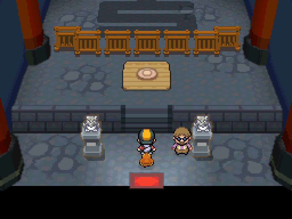 Entering the gym.  Stone floors, a wooden platform ahead that can carry the player up to the battlefield high above.