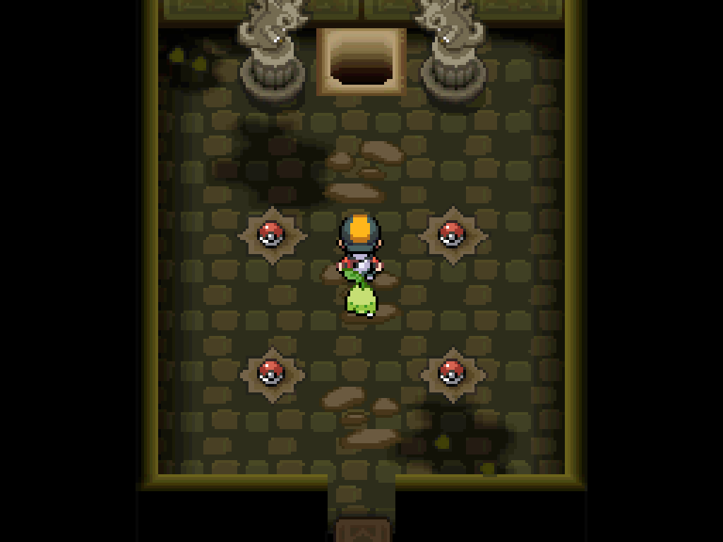 A new chamber hidden behind the previous one.  Darker stones, many items on the floor.  At the back, two Pokémon statues flank a dark hole in the floor.