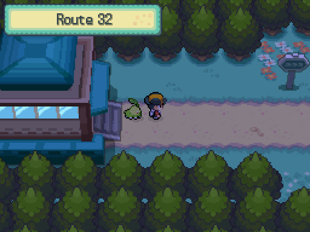 Stepping onto route 32: trees, a dirt path, a signpost, many flowers.