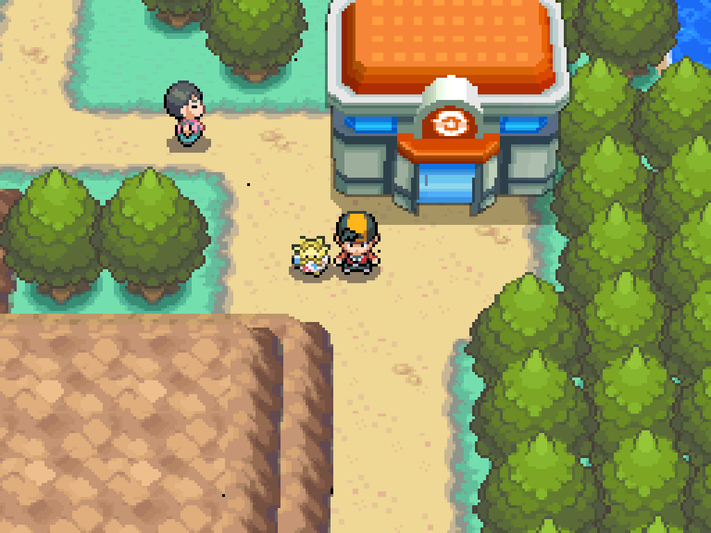 Standing outside a Pokémon Centre on route 32.  Trees all around, a dirt path, cliffs to the southwest.