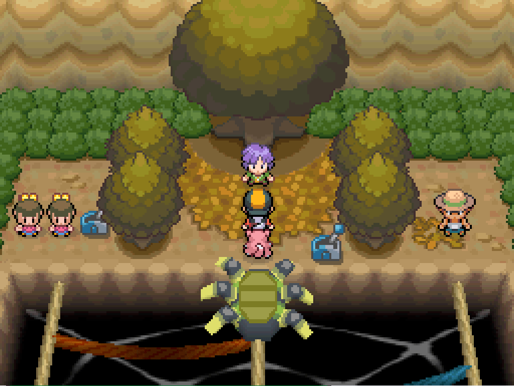 At the back of the Azalea Gym, standing in front of Bugsy.  There is a large tree behind him and many fallen leaves on the floor.