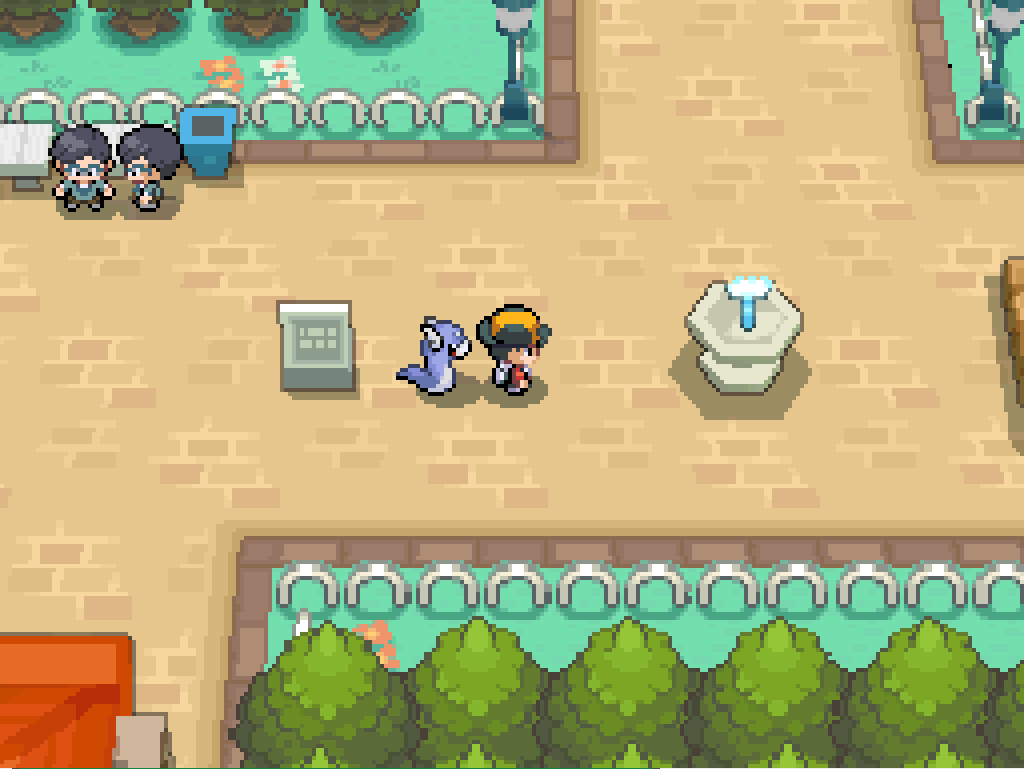 Entering National Park: wide, paved paths, white hoop fences, park benches, trees, flowers, a fountain.