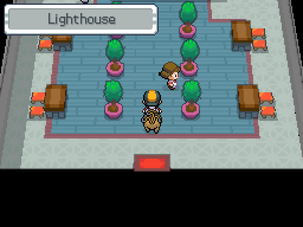 Stepping inside the lighthouse: a ground floor lobby with benches, seats and two rows of ornamental plants.