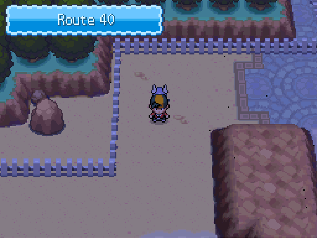 Stepping onto route 40: sand, rocks, a white fence.