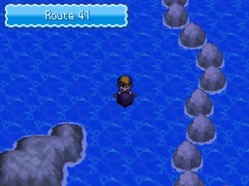 Swimming onto route 41: open sea, a line of grey boulders blocks the way to the east.