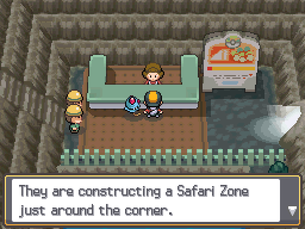 Inside the cave. Two men in hard-hats block a stairway to the west. A sign nearby advertises the Safari Zone. Talking to a woman behind a desk: They are constructing a Safari Zone just around the corner.