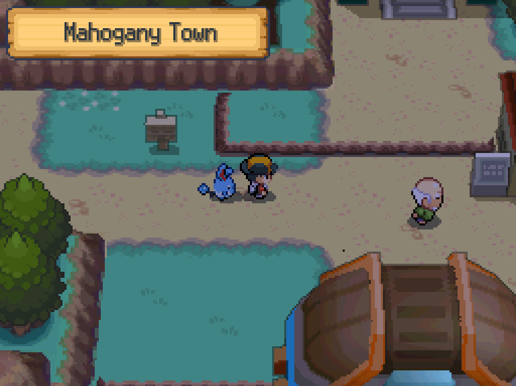 Entering Mahogany Town: dirt paths, ledges, wooden houses, a gym.